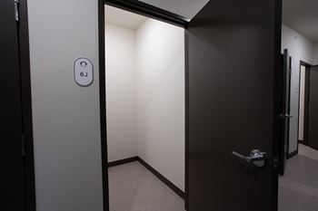 an open bathroom door with a logo on it at Riverhouse Apartments, Fargo, North Dakota