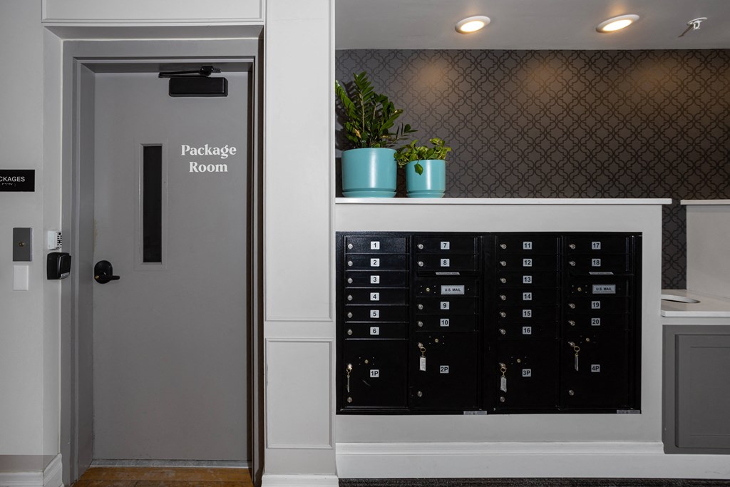 a room with a door to a locker and a shelf with potted plants  at Dillard Apartments, Fargo, ND 58102