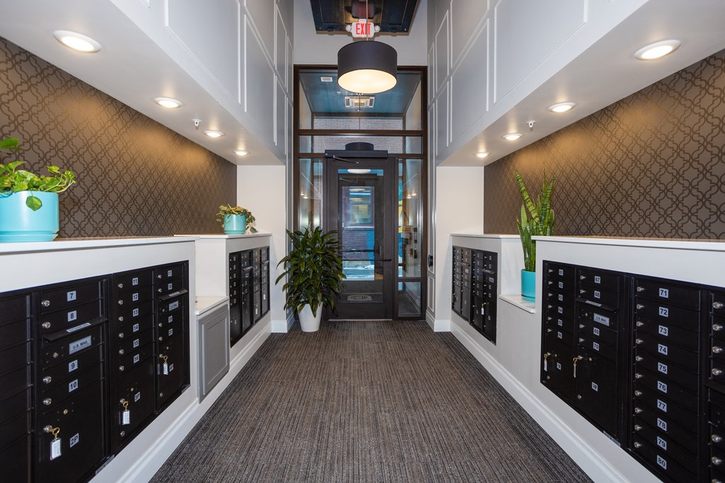 a view down the hallway of a large white office with a black door at the end of  at Dillard Apartments, Fargo, ND, 58102