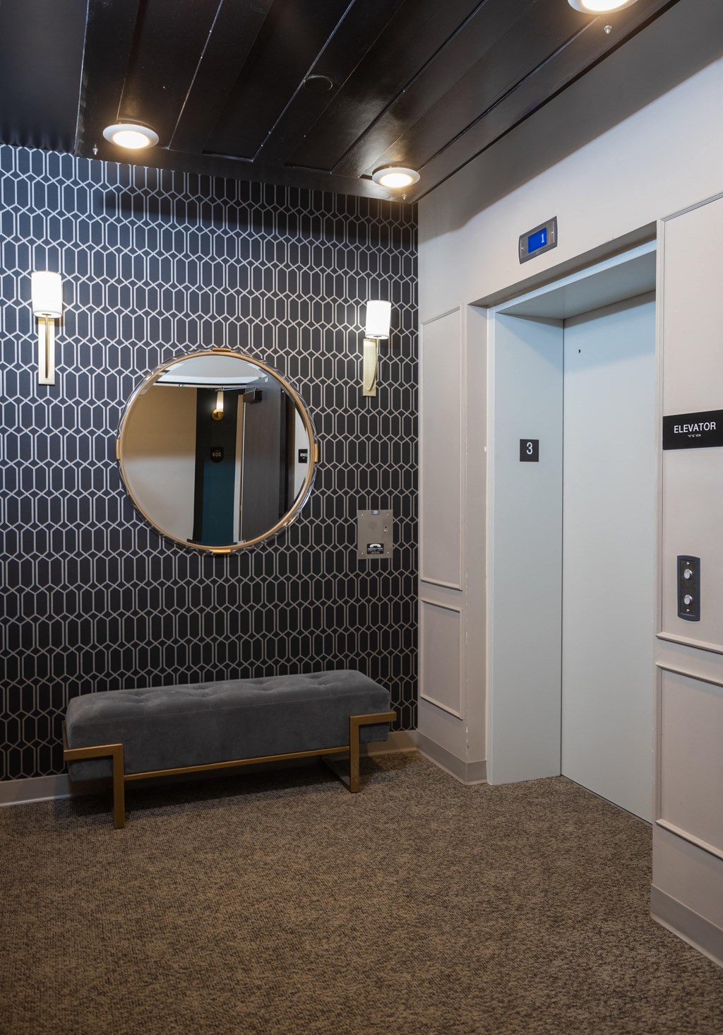 a seating area with a mirror and a bench in front of a door  at Dillard Apartments, Fargo, North Dakota, 58102