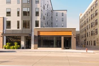 A view of the front of a building on a city street at Kesler Apartments in Downtown Fargo, Fargo, ND 58102