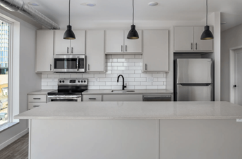 Fully-Equipped Kitchen with White Cabinetry and Stainless-Steel Efficient Appliances at Kesler Apartments in Downtown Fargo, Fargo, North Dakota