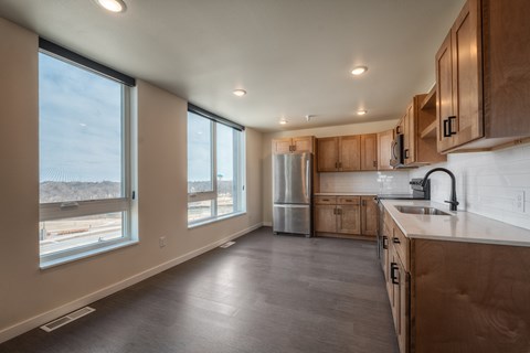 A kitchen with wooden cabinets and a refrigerator.