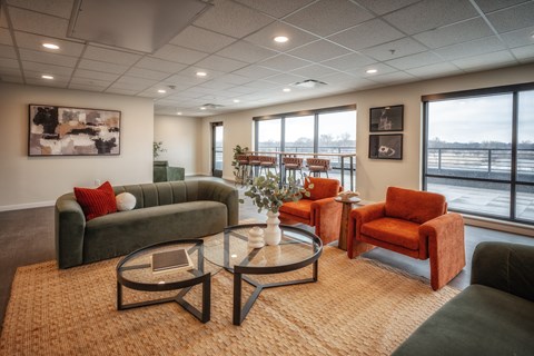 A living room with a couch, chairs, and a coffee table.