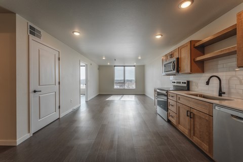 A spacious kitchen with wooden cabinets and a modern design.