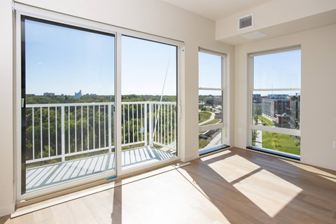 a living room with large windows and a view of the city