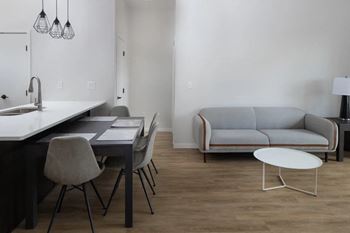 a living room and dining room with a couch and a table at Mercantile on Broadway, Fargo, ND 58102