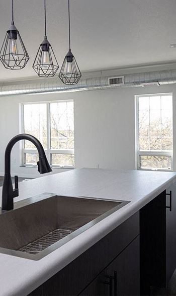 a kitchen with a sink and a window  at The Landing at 1001 NP Apartments in Fargo, ND 58102