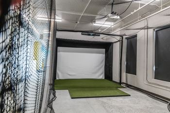 a cage in a gym with a green carpet at Riverhouse Apartments, Fargo, ND