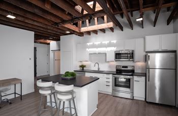 a kitchen with white cabinets and stainless steel appliances at Bostad Apartments, Fargo, ND 58102