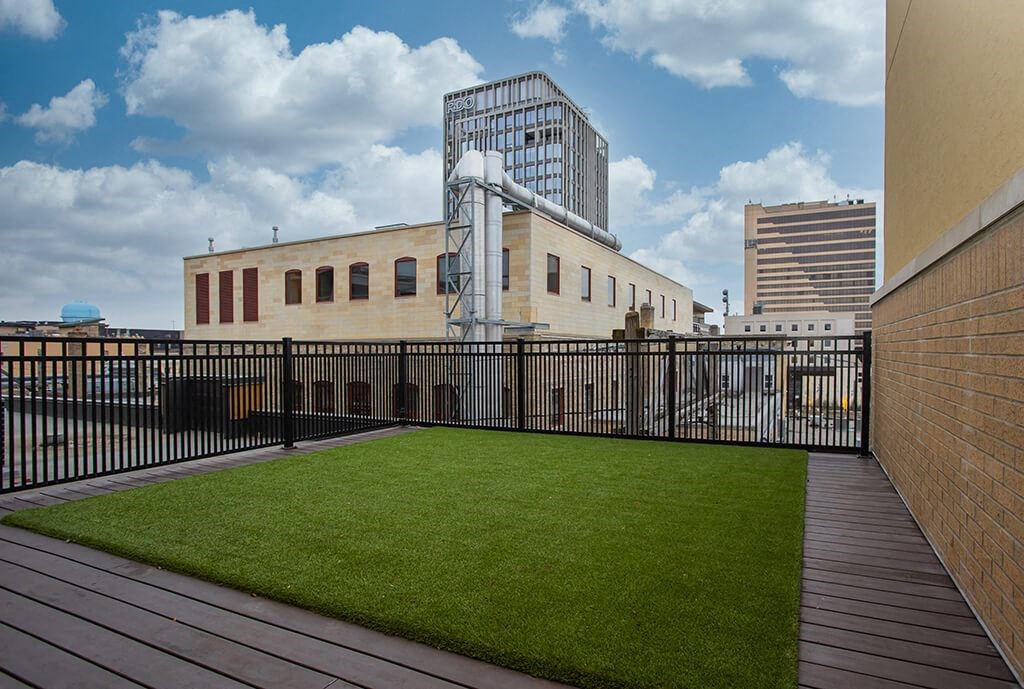 a small astroturf lawn on the roof of a building  at RoCo Apartments, Fargo, North Dakota 58102