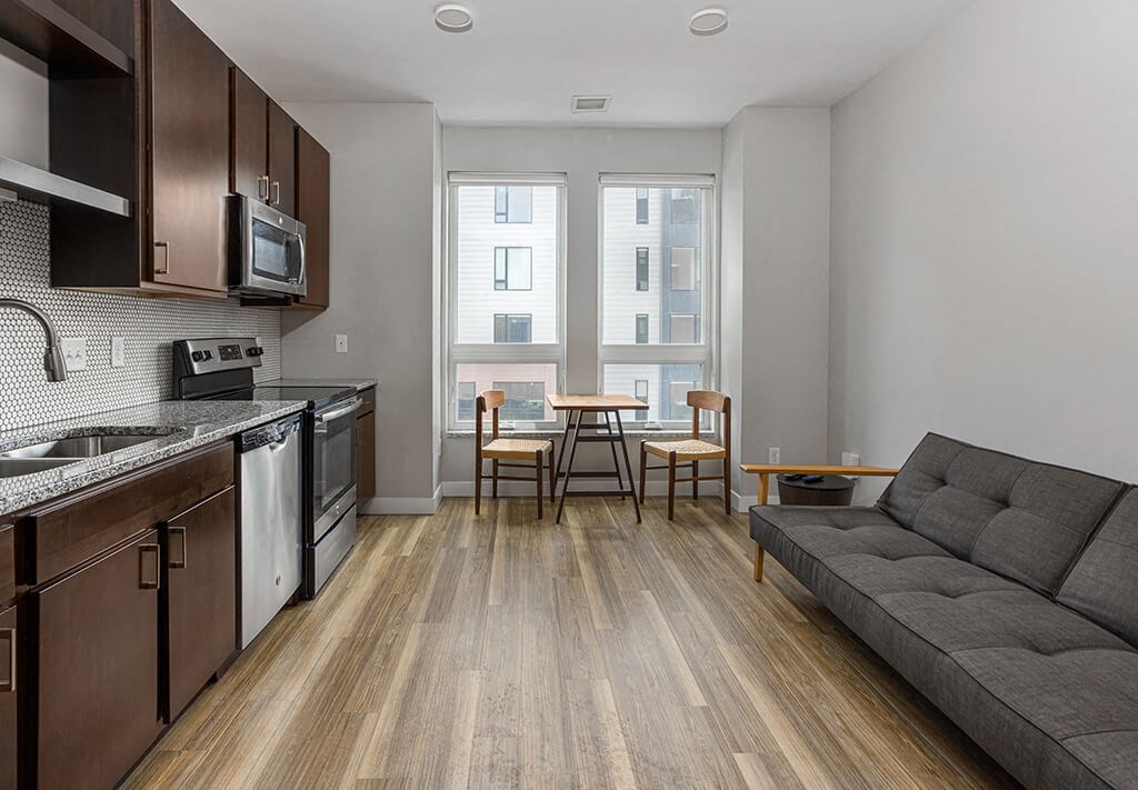 a kitchen and living room in a 555 waverly unit  at RoCo Apartments, Fargo, ND 58102