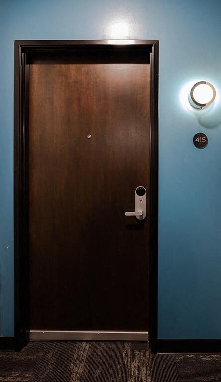 a door with a security camera on the side of it  at RoCo Apartments, Fargo, ND 58102