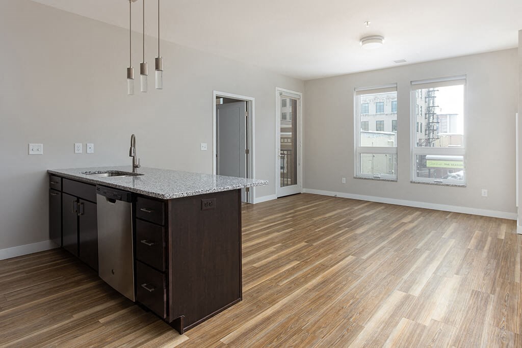 a kitchen and living room in an apartment  at RoCo Apartments, Fargo, ND 58102