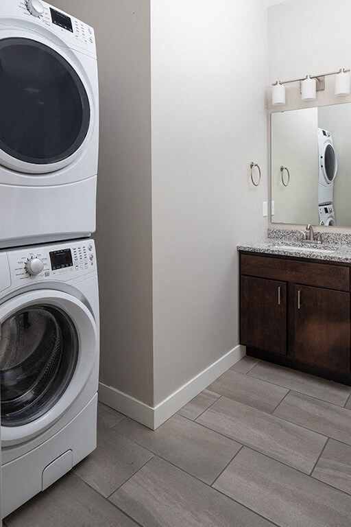 a bathroom with a washer and dryer and a sink  at RoCo Apartments, Fargo, ND 58102