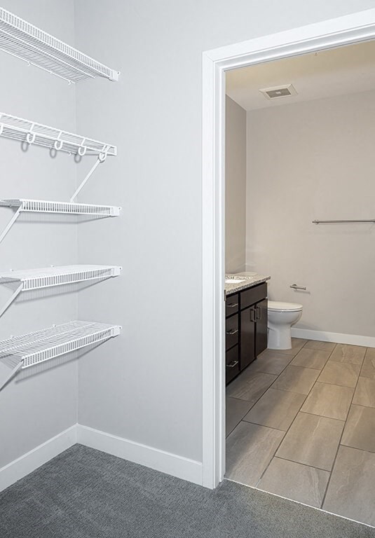 a bathroom with a toilet and a sink  at RoCo Apartments, Fargo, ND 58102