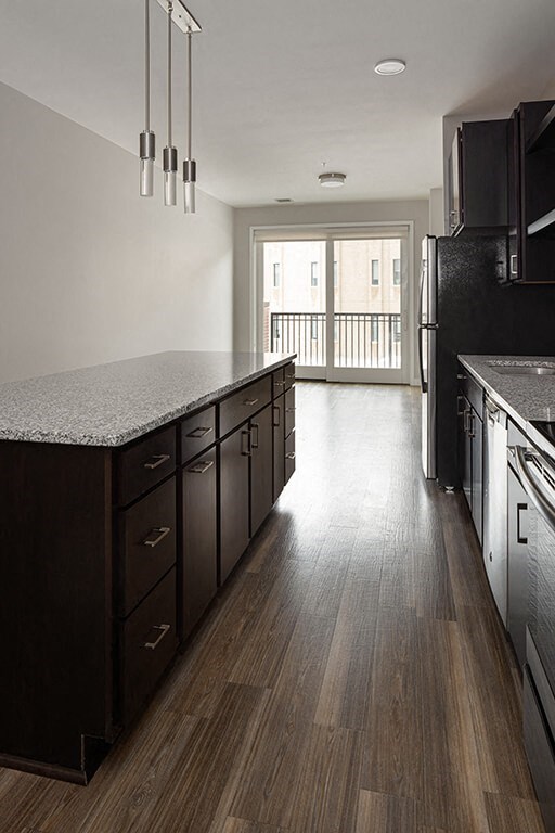 a kitchen with a counter top and a refrigerator at RoCo Apartments, Fargo, ND 58102