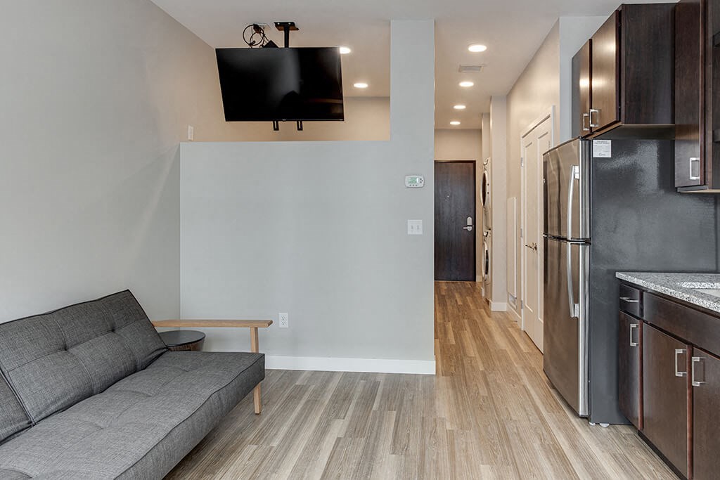 a living room with a couch and a tv  at RoCo Apartments, Fargo, North Dakota 58102