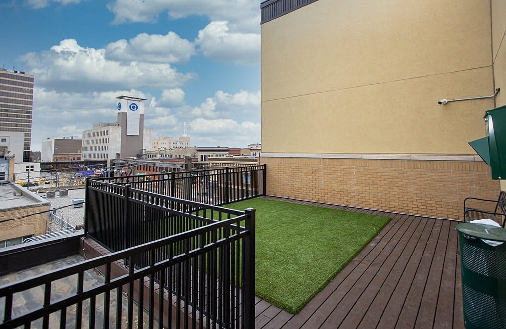 a balcony with green turf and a view of the city at Dillard Apartments, Fargo, North Dakota 58102