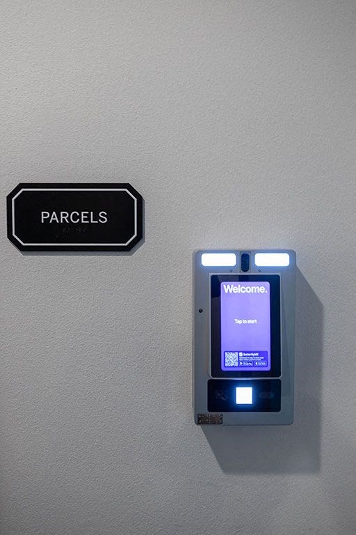 an electronic device on a wall next to a sign at The Landing at 1001 NP, Fargo, ND 58102