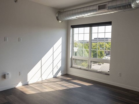 an empty room with a large window at The Landing at 1001 NP, Fargo, ND 58102