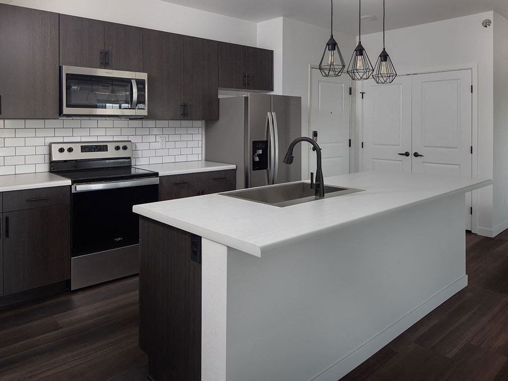 a kitchen with a sink stove and refrigerator at The Landing at 1001 NP, Fargo, 58102