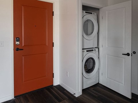 a door is open to a laundry room with a washer and dryer at The Landing at 1001 NP, Fargo, North Dakota 58102
