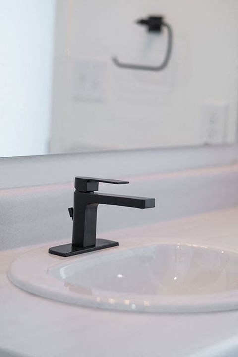 a bathroom sink with a black sink faucet at The Landing at 1001 NP, Fargo, ND 58102