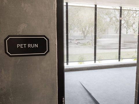 a sign that says pet run on the side of a building at The Landing at 1001 NP, Fargo, ND, 58102