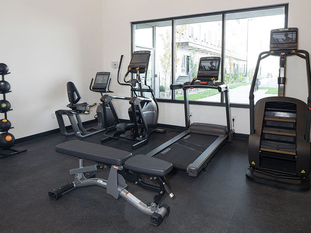 a gym with treadmills and other exercise equipment at The Landing at 1001 NP, Fargo, North Dakota, 58102