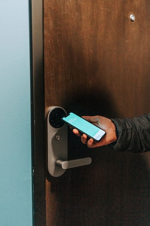 a person holding a cell phone in their hand  at RoCo Apartments, Fargo, North Dakota 58102