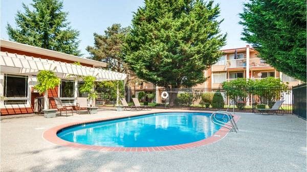 a large swimming pool in front of a building