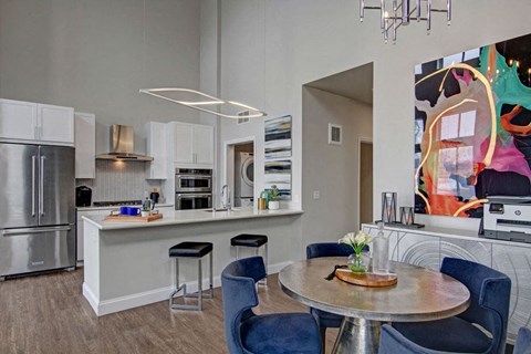 A modern kitchen with a dining table and chairs.