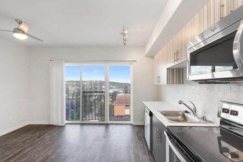 Galley style kitchen with stainless steel appliances and overhead lighting Vive Kitchen - Photo Gallery 5