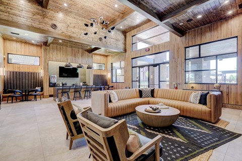 a living room with a couch and chairs and a table