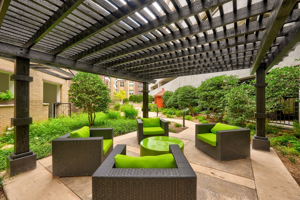 a pergola with a fire pit in the middle of a courtyard