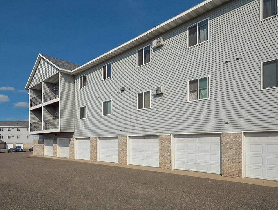 the side of a building with white garage doors