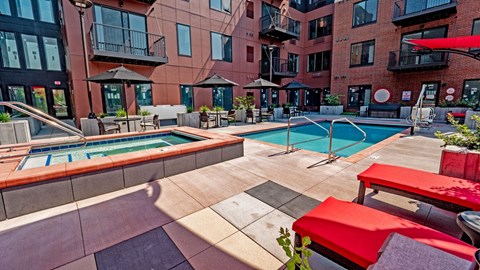 our apartments have a pool and lounge area with tables and chairs