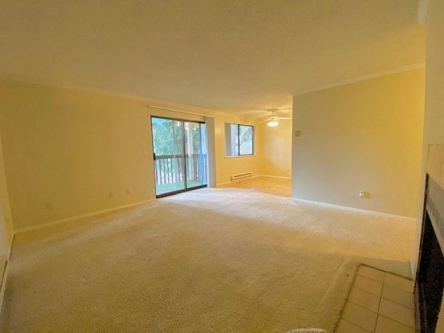 an empty living room with a door to a balcony
