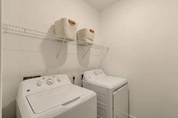 a laundry room with two washes and a dryer