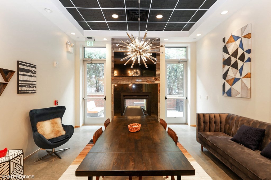 a dining room with a large wooden table and a fireplace