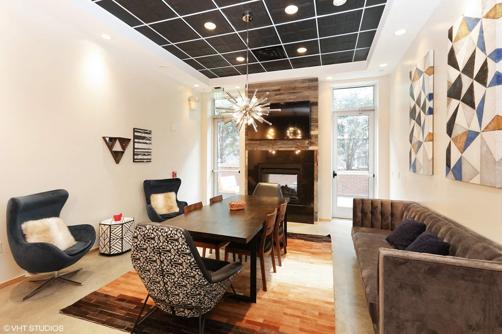 A modern living room with a dark blue chair and a wooden table.