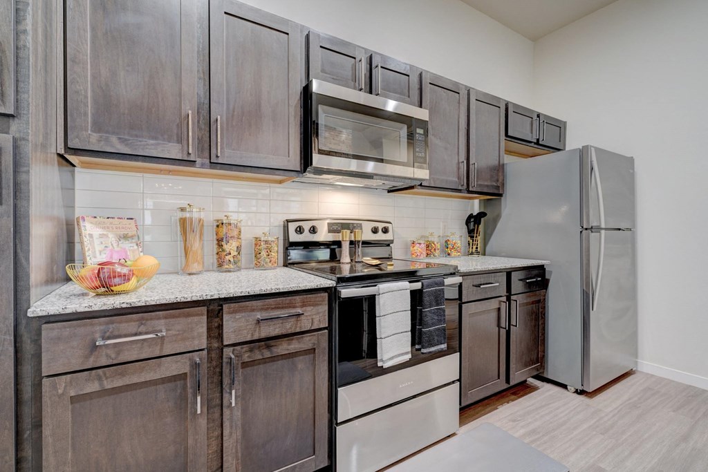 a kitchen with stainless steel appliances and wooden cabinets
