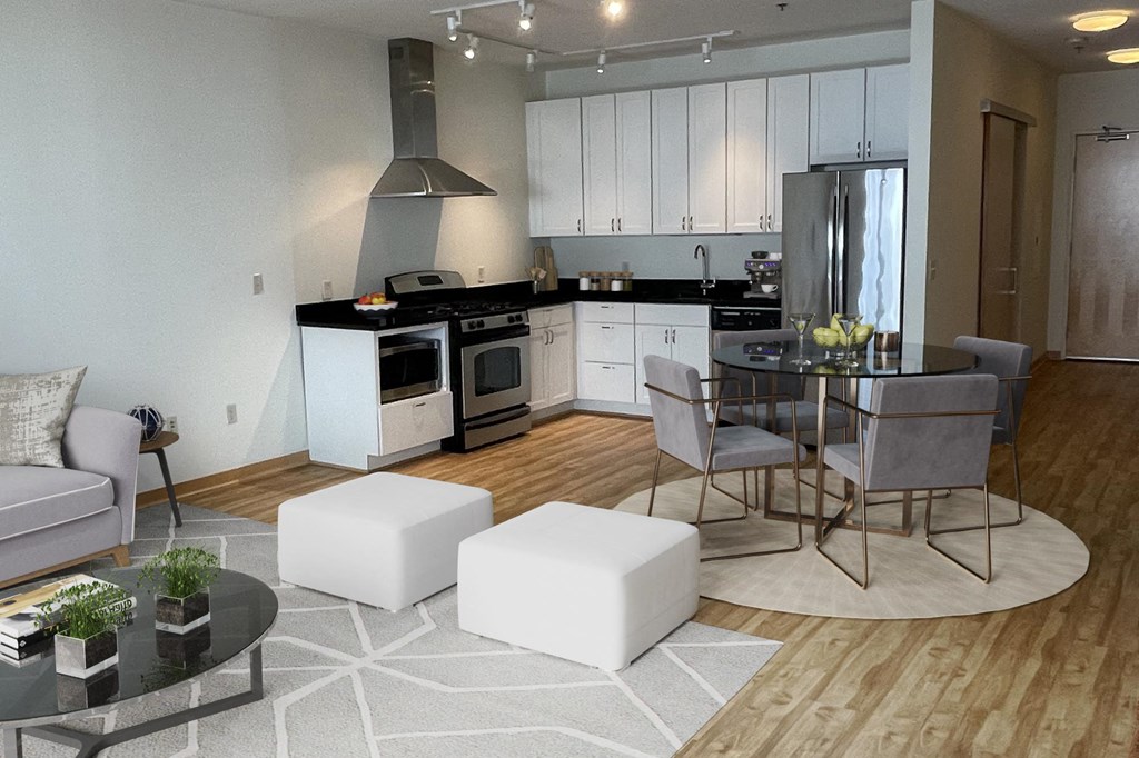 A modern kitchen with white appliances and a dining table set for four.