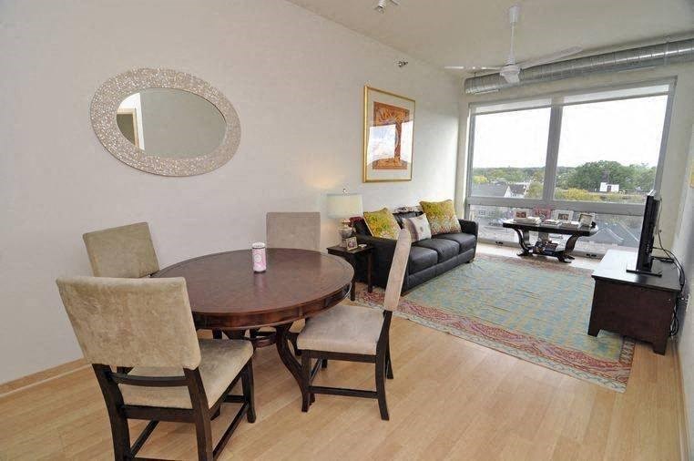 a dining room with a wooden table and chairs