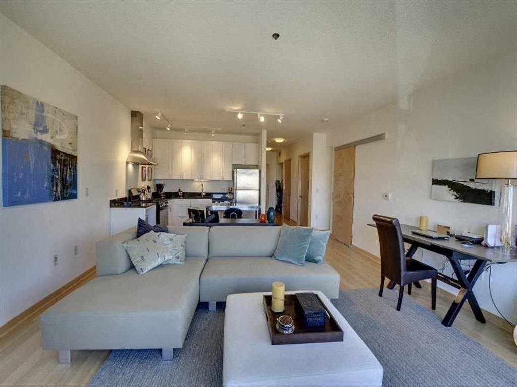 A living room with a grey couch and a coffee table.