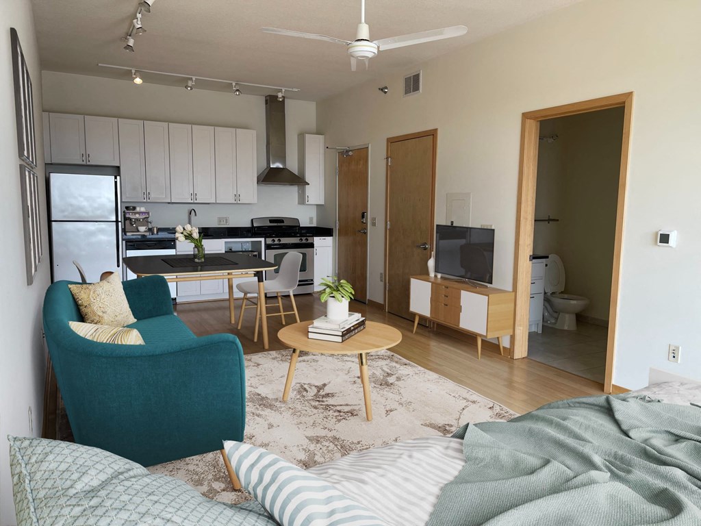 a living room and kitchen with a couch and a table