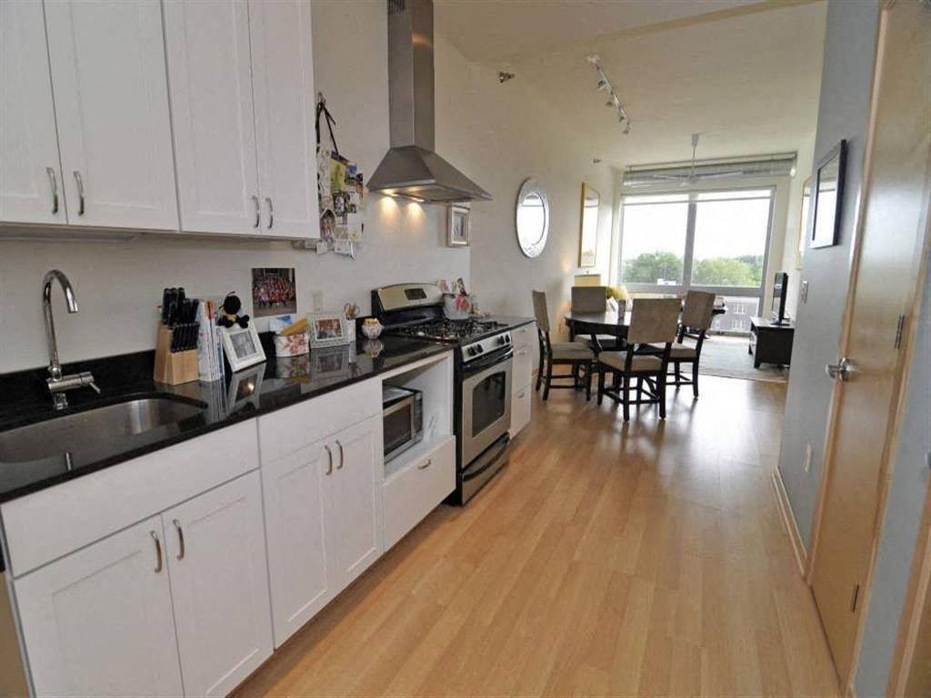 a kitchen with stainless steel appliances and white cabinets