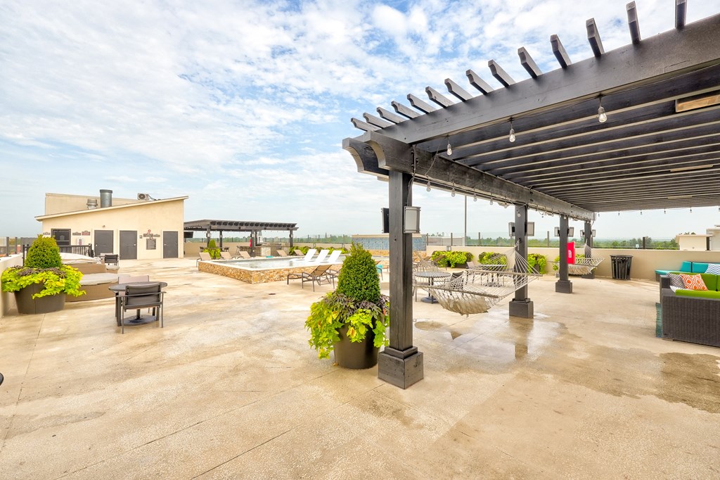 the patio has a pool and lounge area with chairs and tables