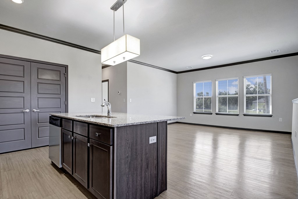 an empty kitchen and living room with a counter top